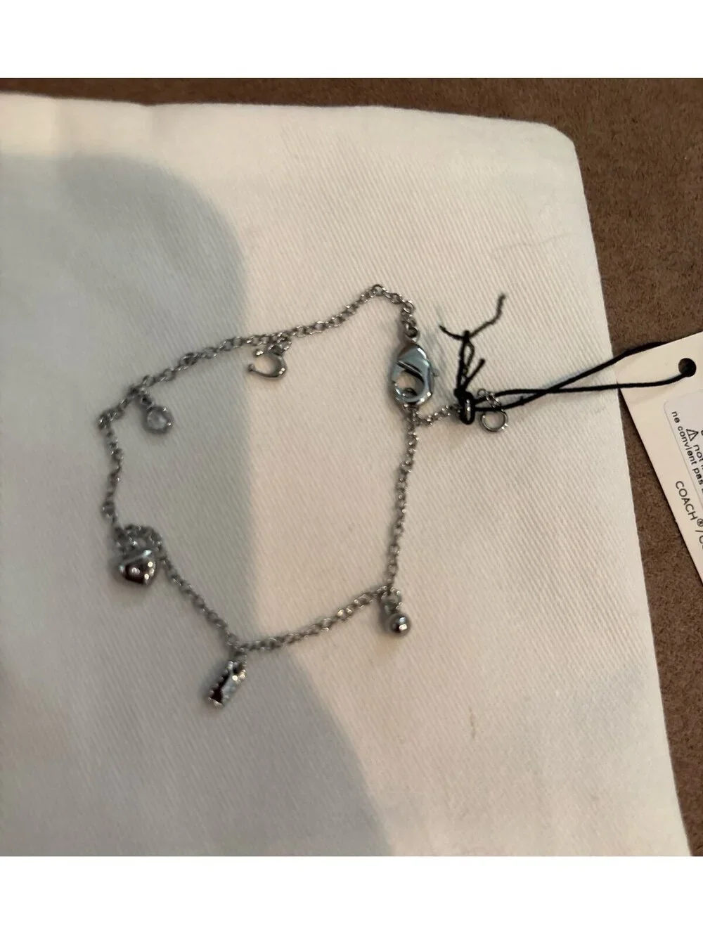 Coach Silver Tone Charm Bracelet with Heart and Logo Charms